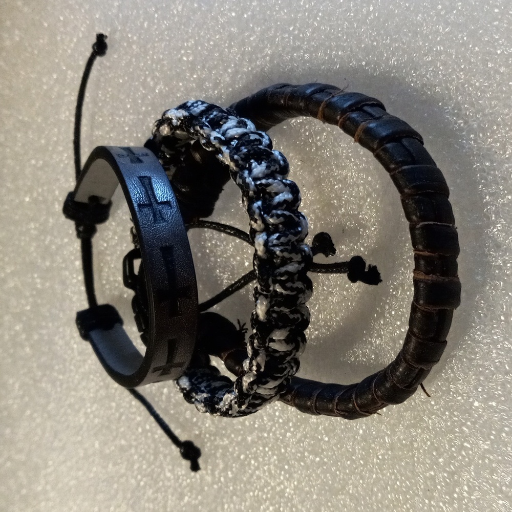 3 bracelets. 2 leather and one nylon cord.